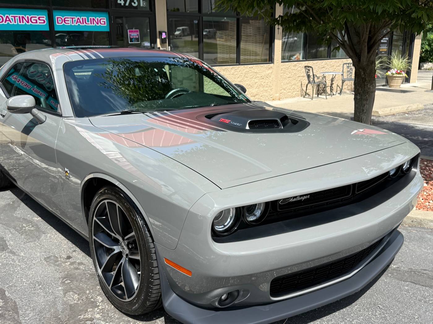 The same grey Dodge Challenger clean outside the shop on Route 8